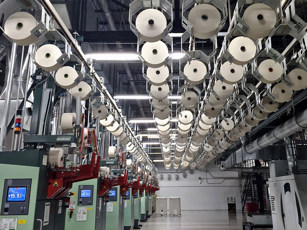 Circular knitting machinery used in Los Angeles Apparel fabric production.