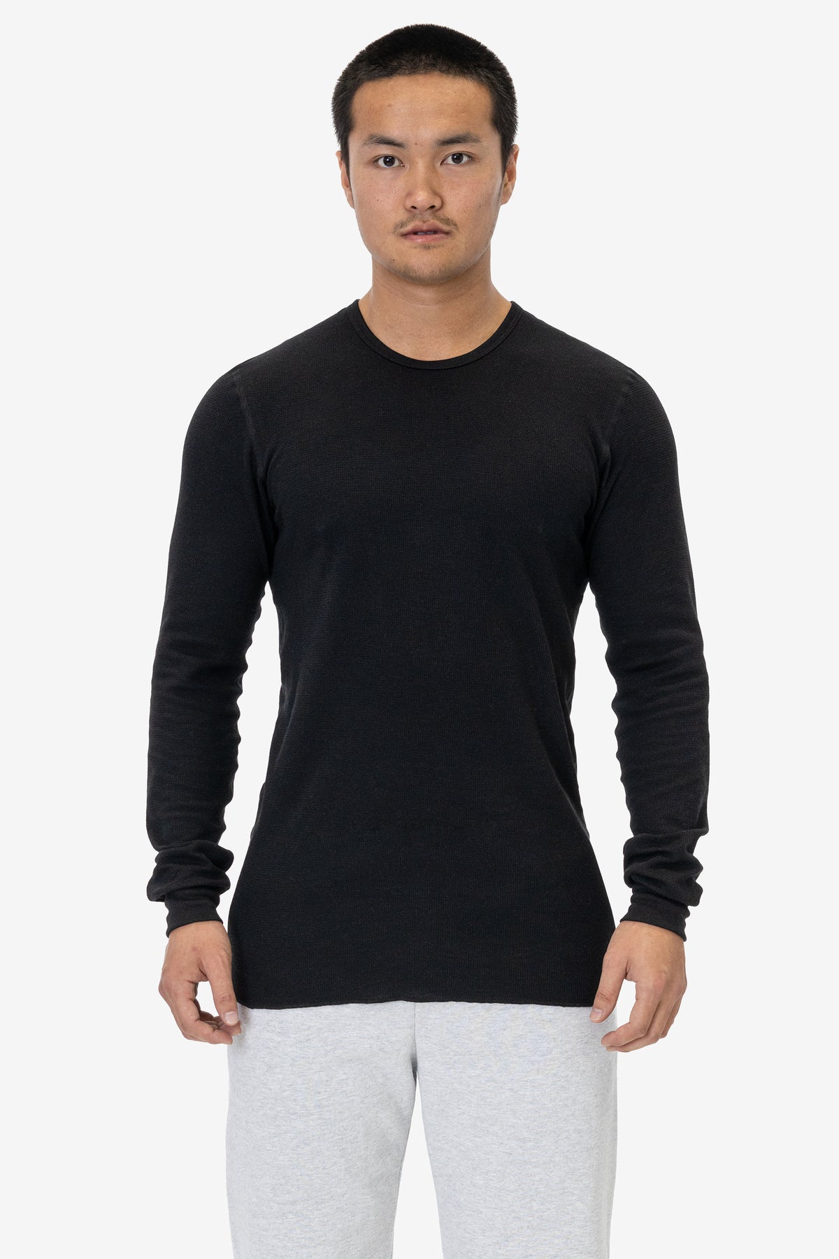 Model wearing the black Poly-Cotton Thermal Long Sleeve Crewneck to show its lighter waffle-knit construction